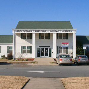 Two-story building with single-story wings and parking lot "Jacksonville Museum of Military History"