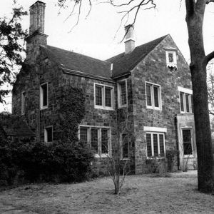 Multistory brick house with framed windows and chimneys