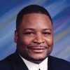 African-American man with mustache in suit