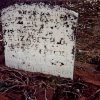 Weathered gravestone in cemetery