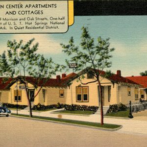 Single-story apartment buildings with red roofs on street