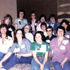 Group of white women in colorful clothing and name tags