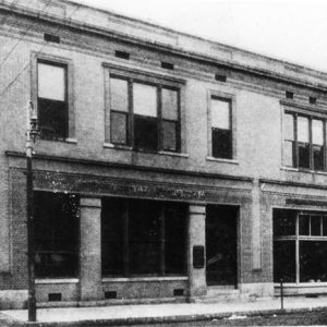 long two-story building with street lamp and large windows