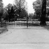 "U.S. National Cemetery" iron gates with gravestones beyond it