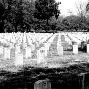 Rows of white gravestones in cemetery