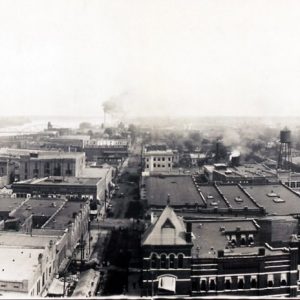 Panorama downtown Little Rock skyline with river to left three bridges and center factory smoke