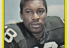 African-American man in football uniform with "Steelers" written above him