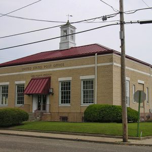 Single-story brick building with cupola on street corner