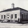 Single-story brick building with cupola on street corner