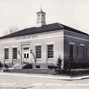 Single-story brick building with cupola on street corner