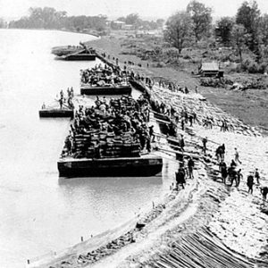 Lake with floating platforms full of workers and levee wall