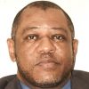 Close-up portrait photo of an African-American man in suit jacket and dress shirt