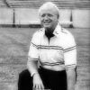 Older white man kneeling on football field