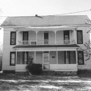 Two-story house with balcony and screened-in porch