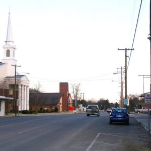 street scene with large steepled church on one side