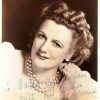 Hand signed portrait white woman smiling curled hair pearl necklace bracelet and blouse