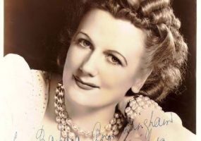 Hand signed portrait white woman smiling curled hair pearl necklace bracelet and blouse