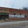 Dilapidated brick storefront on street corner