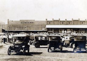 Cars and people crowded in front of "Lester & Patton Co"