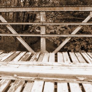 View standing on wooden platform of steel truss bridge