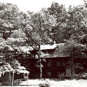 Three-story camp building surrounded by trees