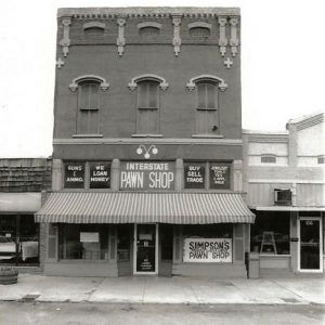 Multistory storefront with single-story stores on either side