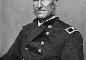 Old white man sitting in military uniform