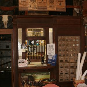 Postman's desk with letter boxes, wanted posters and other artifacts