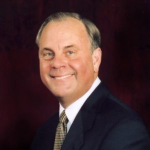 Portrait middle aged white man smiling thin combed hair suit and tie pocket square