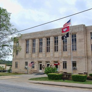 Multistory building with flag pole on street