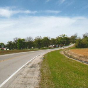 Highway section with buildings and trees in the background