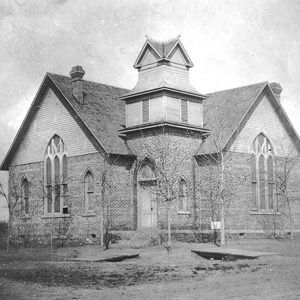 Wood and brick church building with central tower