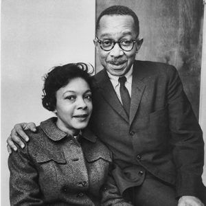 African-American man and woman sitting in chair