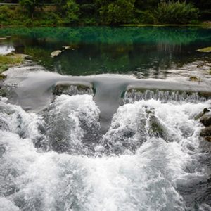 A. Pond with spillway B. Spillway and rushing waterC. Water rushing over dam spillway