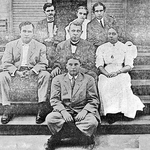 African-American men and women sitting on front porch steps