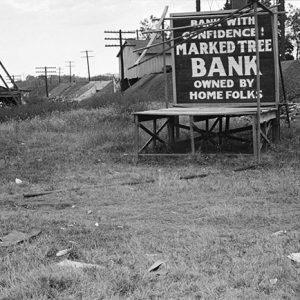 Billboards in a field with town in the background