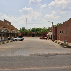 Single-story brick buildings on paved streets