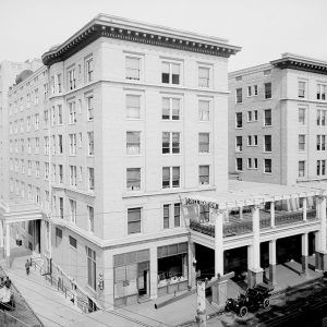 Multistory building with cars on city street