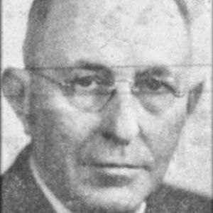 White man with glasses in suit and tie