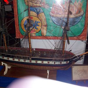 Model ship and banner in glass case