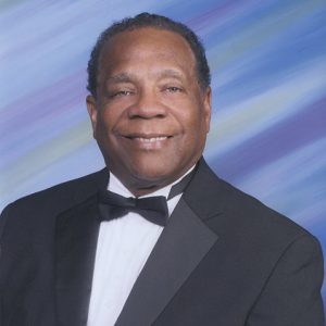 African-American man smiling in suit and bow tie