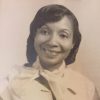 African-American woman smiling in sleeveless top