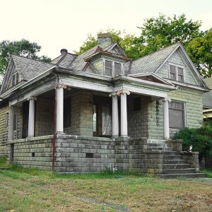 Two-story brick house with corner porch and steps