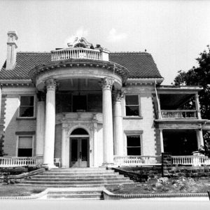 Multistory house with round front porch with columns