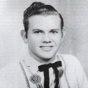 Young white man with slicked back waved hair and bow tie