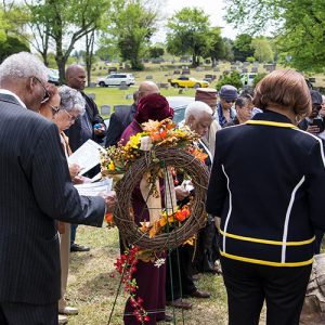 mixed crowd in cemetery at dedication ceremony