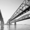 three steel bridges running parallel across a river