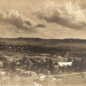 View overlooking town buildings and houses with hills in the background