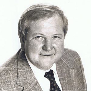 Older white man in suit jacket and tie