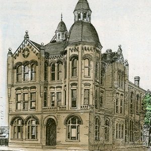 Tall building with rounded towers, arched entrance and windows